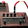<p style='text-align: left; margin-bottom: -10px;'>Balanced modulator and distortion circuitry inside tabletop switchboard (comb filter in background)</p><br>Photo by Seze Devres